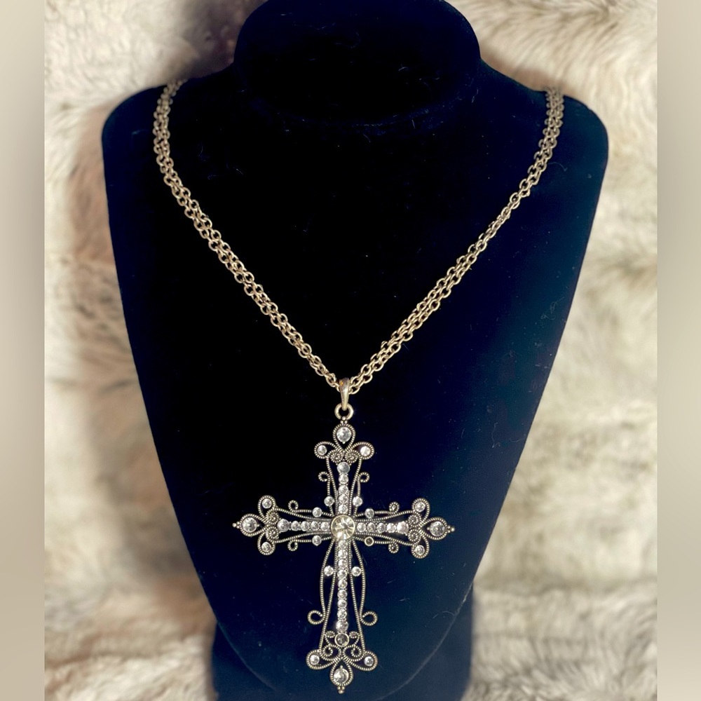Long cross necklace.